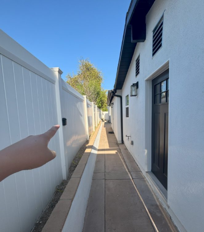 The walkway inside the gate, with your door on the right and the lock box on the fence